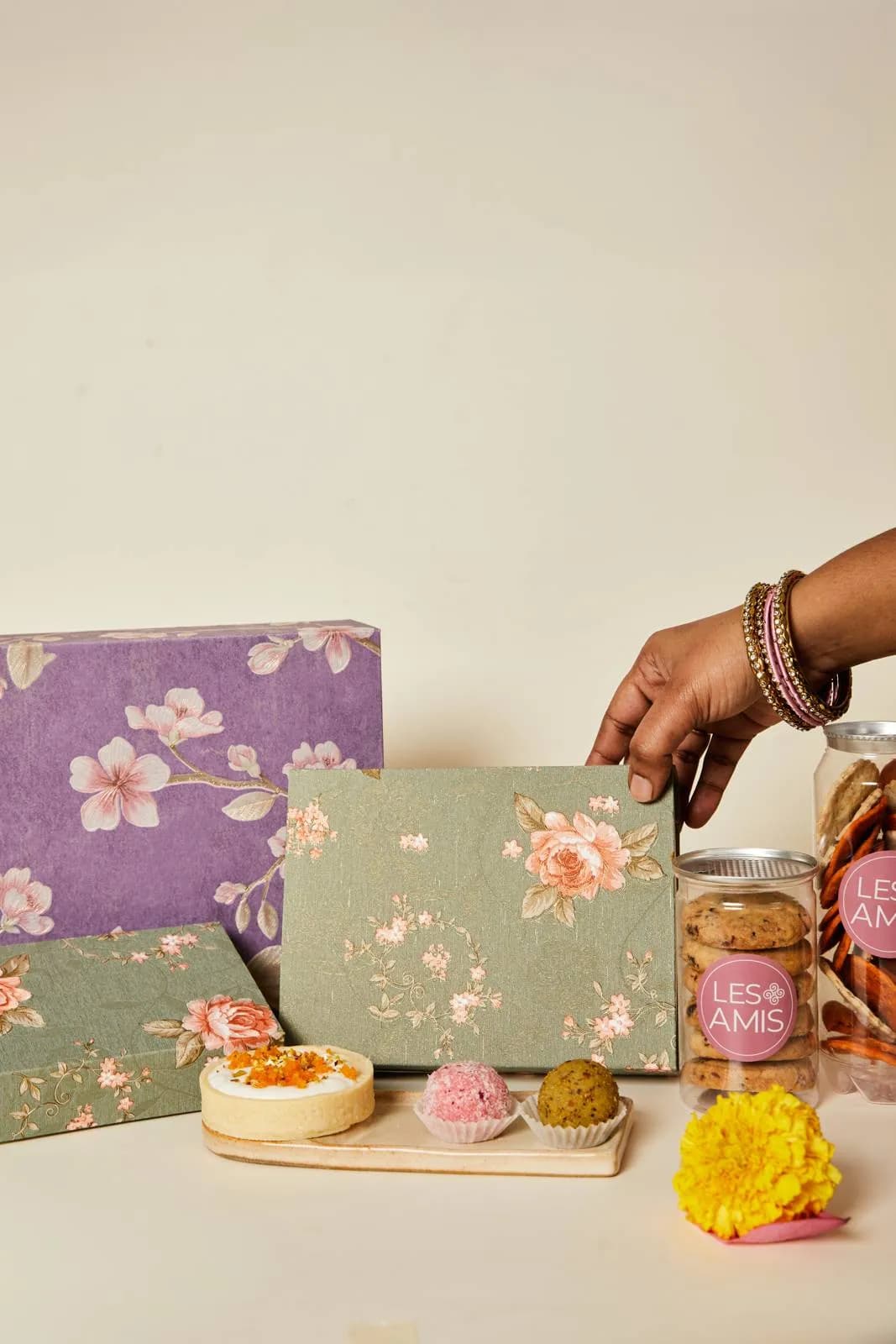 Les Amis Diwali hampers — lavender floral boxes, jars of biscuits and a tray of pedas